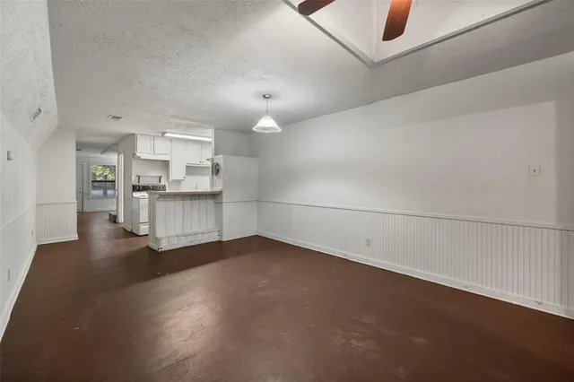 an empty room with a kitchen and a sink