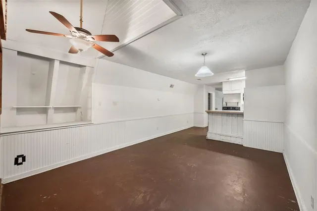 a view of a kitchen with a sink and a refrigerator