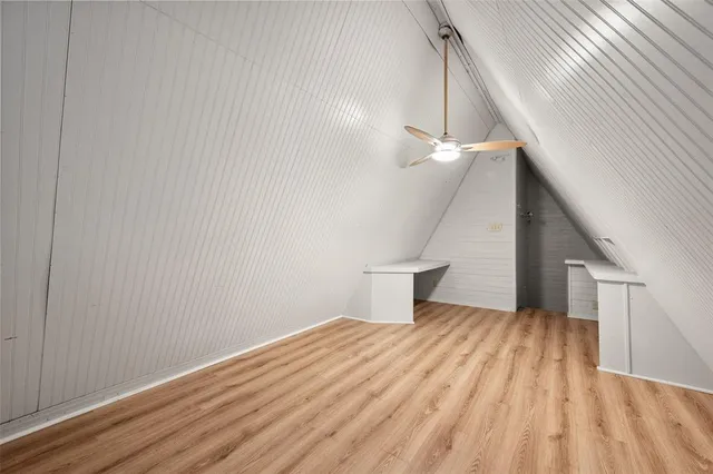 a view of a room with wooden floor and white walls