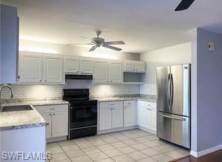 152 Lake Point Lane, Unit 4A Naples, FL 34112 - Photo 5 of 15 a kitchen with stainless steel appliances granite countertop a stove a refrigerator and a sink