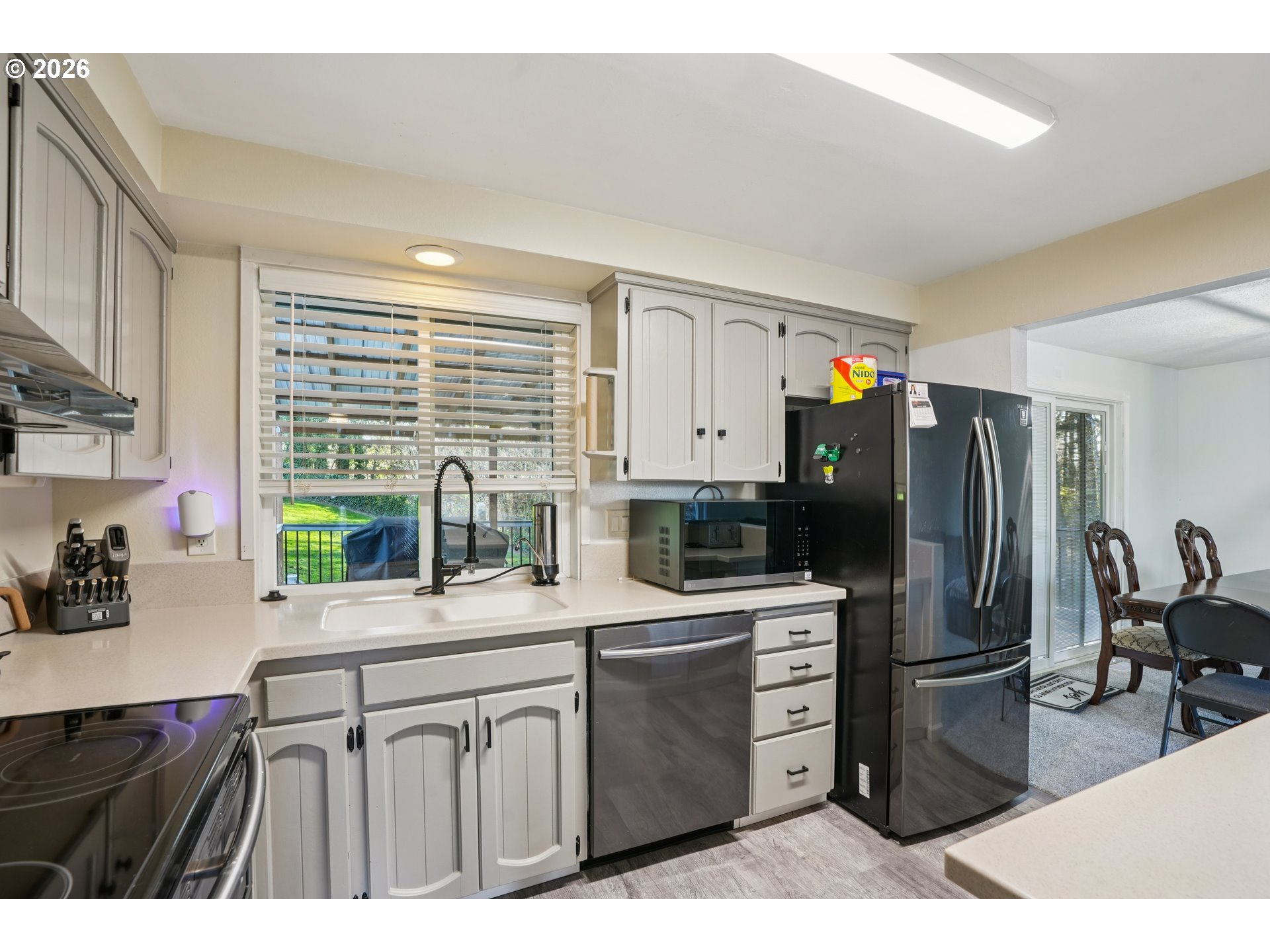 3454 Northeast 5th Court Gresham, OR 97030 - Photo 13 of 34 a kitchen with a refrigerator and a stove top oven