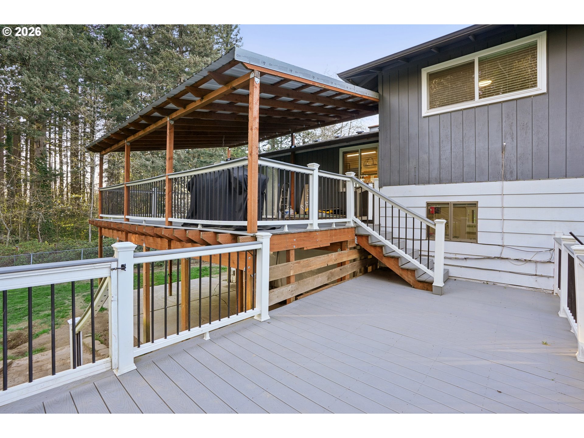 3454 Northeast 5th Court Gresham, OR 97030 - Photo 33 of 34 a view of a house with a wooden deck and wooden fence