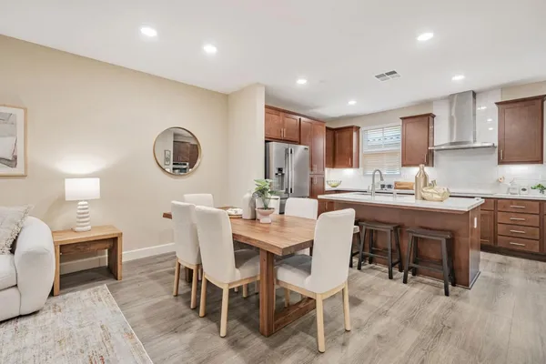 a dining room with a wooden table and chairs