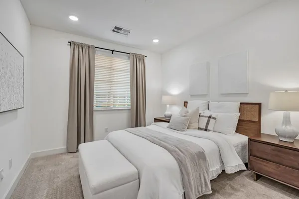 a bedroom with a large bed and a window