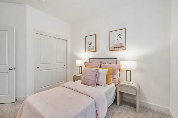 a bedroom with a bed and a lamp