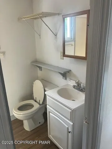 a bathroom with a toilet sink and mirror