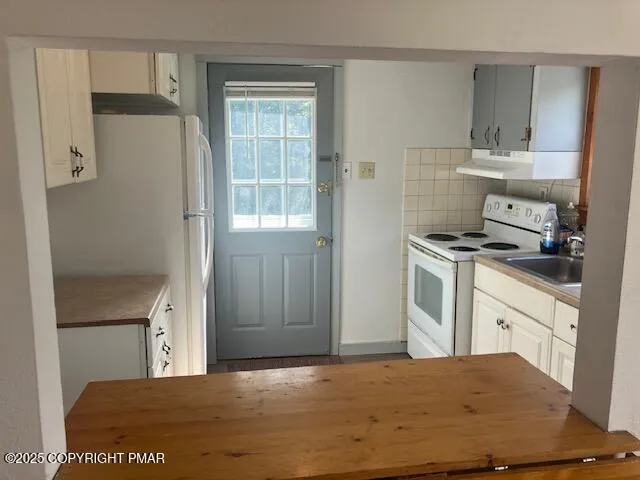 a kitchen with stainless steel appliances granite countertop a refrigerator and a stove