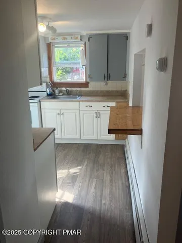 a view of kitchen with sink window and cabinets