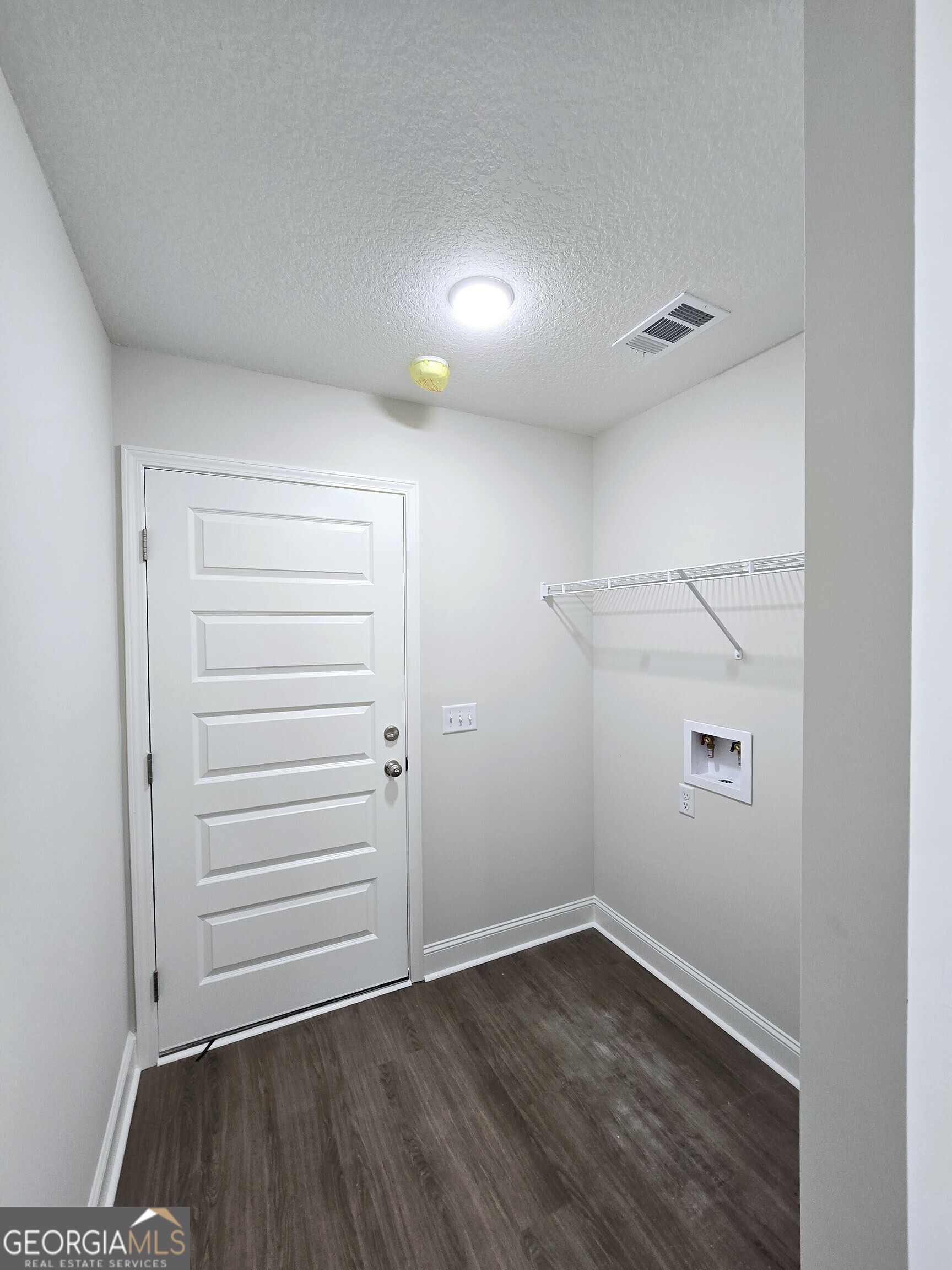 26466 Turner Road Metter, GA 30439 - Photo 11 of 39 an empty room with wooden floor and cabinet