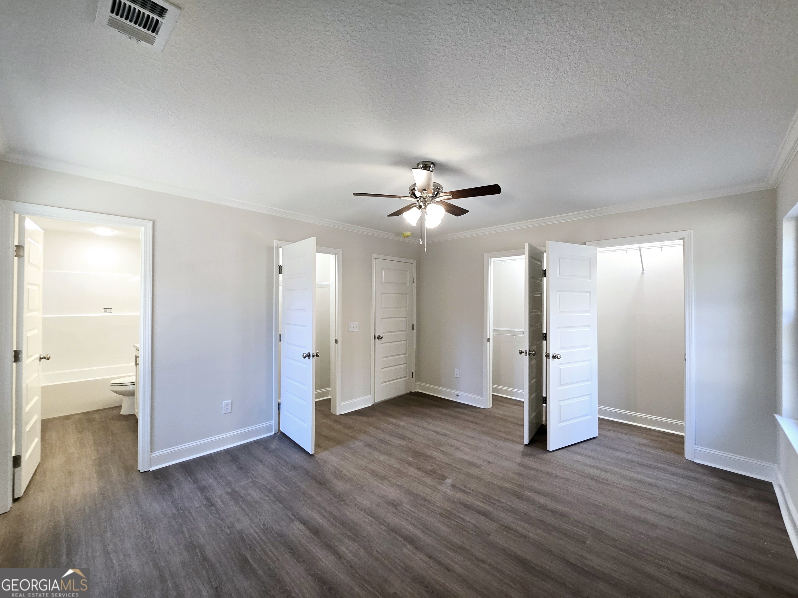 26466 Turner Road Metter, GA 30439 - Photo 12 of 39 a view of an empty room with wooden floor and a ceiling fan