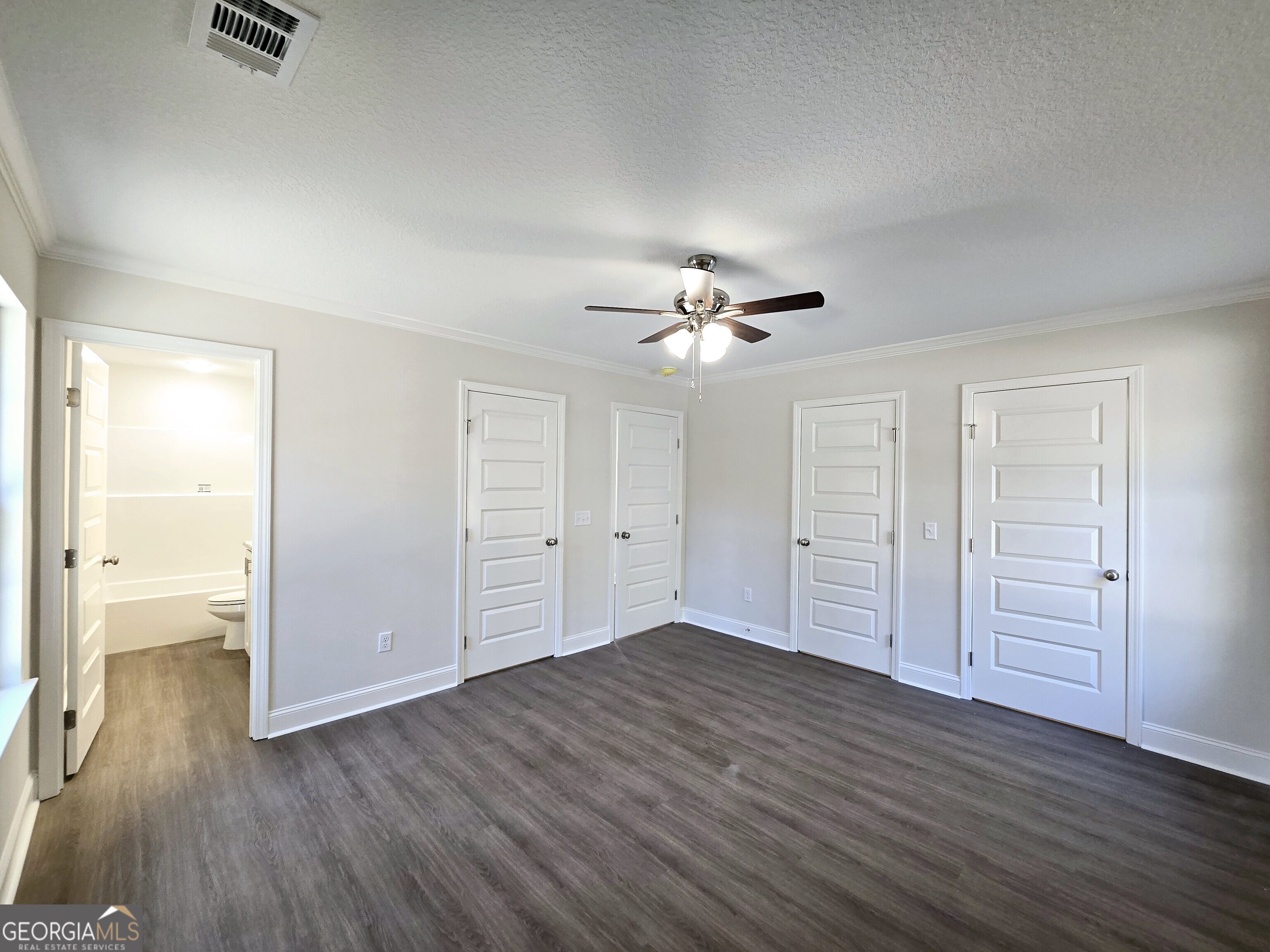 26466 Turner Road Metter, GA 30439 - Photo 13 of 39 an empty room with wooden floor closet and windows
