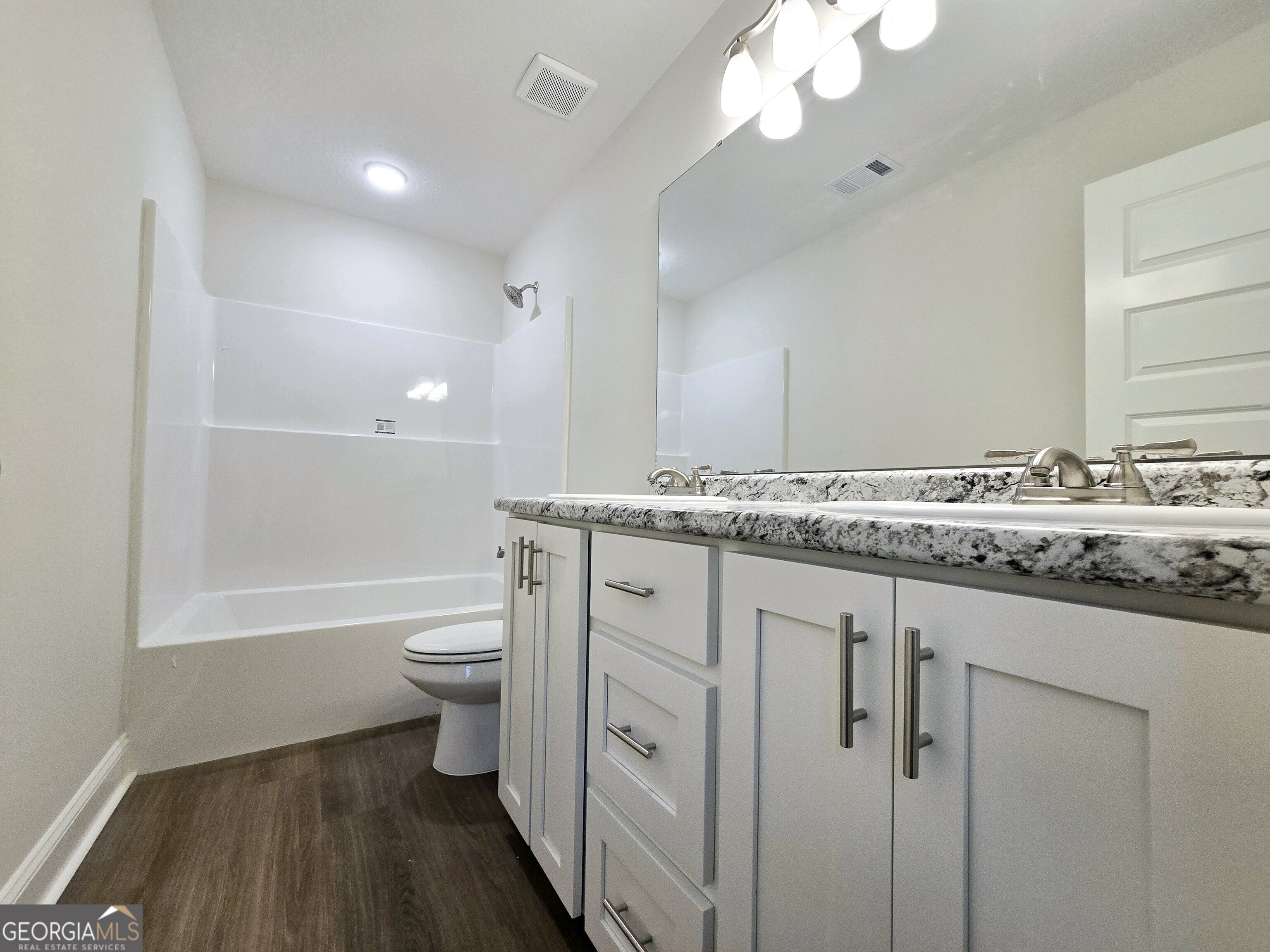 26466 Turner Road Metter, GA 30439 - Photo 14 of 39 a bathroom with a granite countertop sink toilet and shower