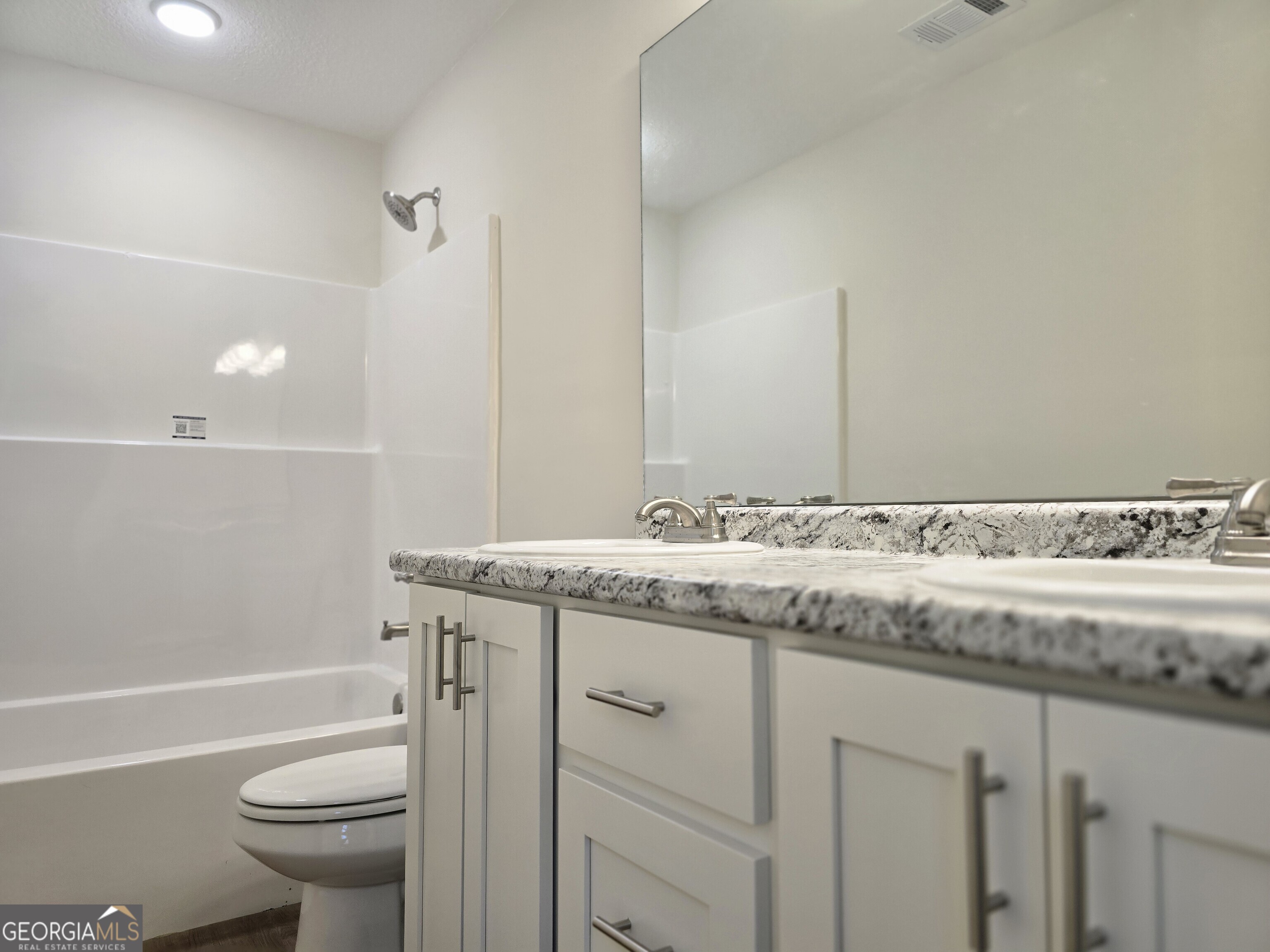 26466 Turner Road Metter, GA 30439 - Photo 17 of 39 a bathroom with a granite countertop sink a toilet and a bathtub