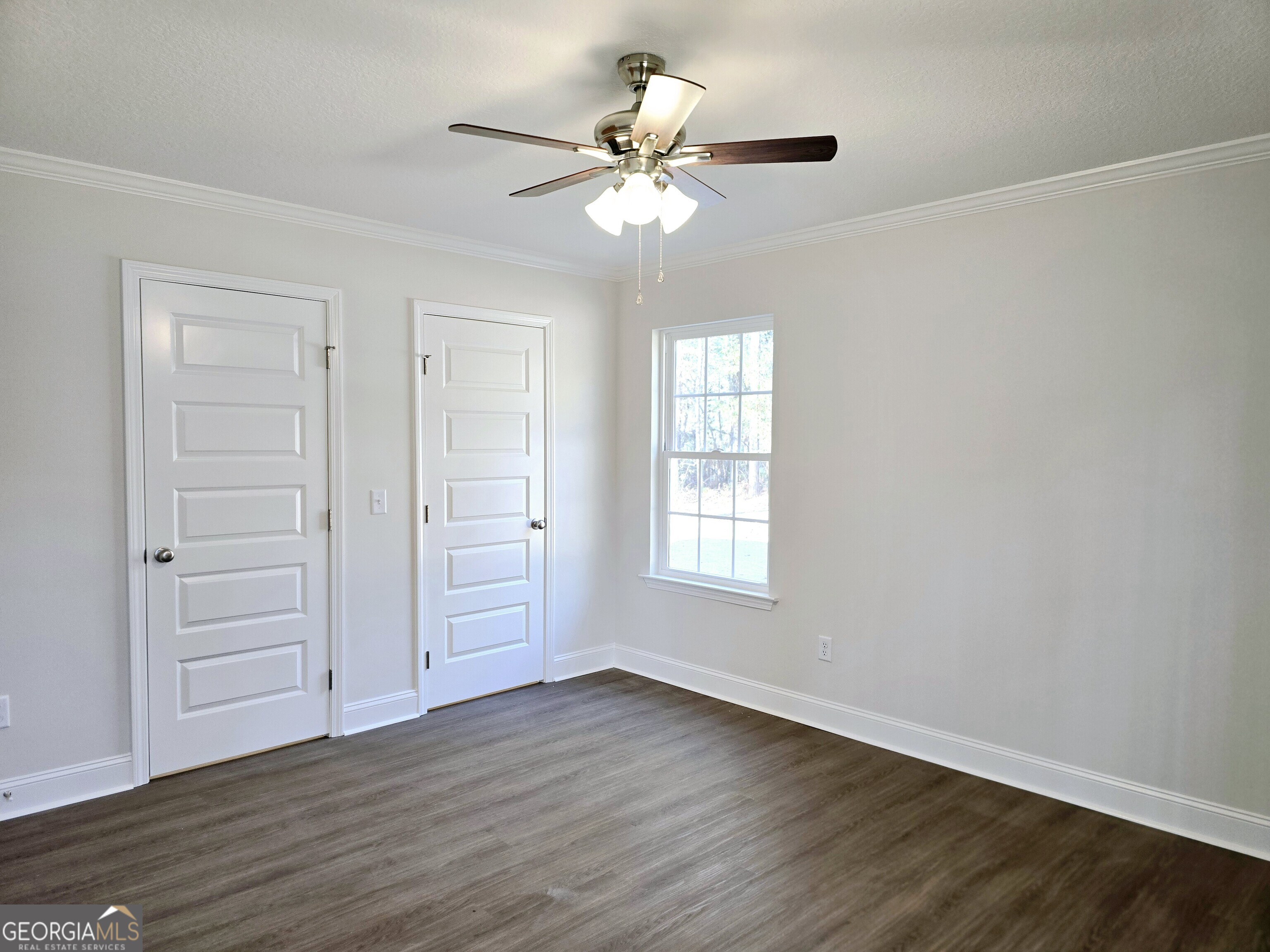 26466 Turner Road Metter, GA 30439 - Photo 19 of 39 a view of an empty room with wooden floor and a window