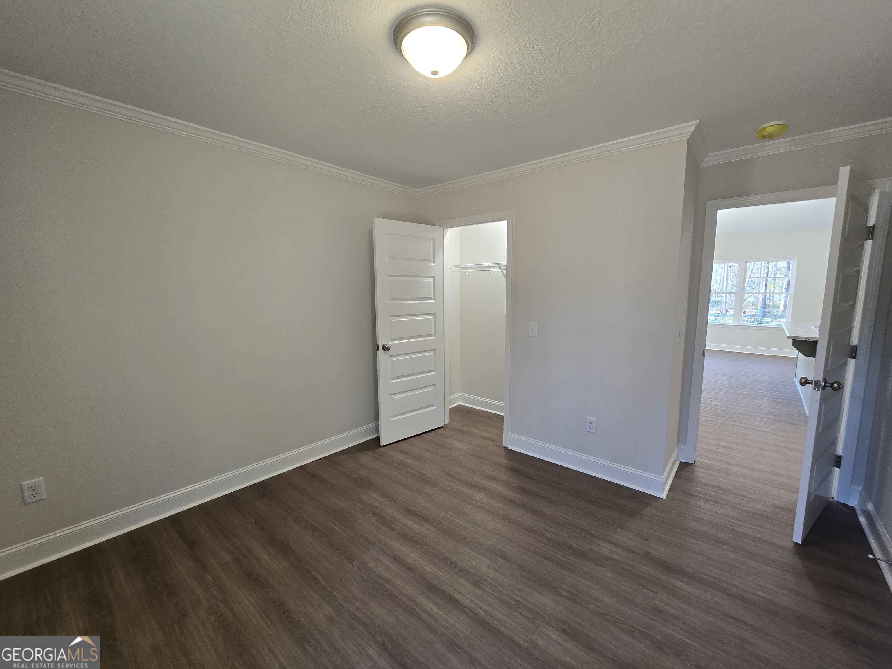26466 Turner Road Metter, GA 30439 - Photo 20 of 39 an empty room with wooden floor and mirror