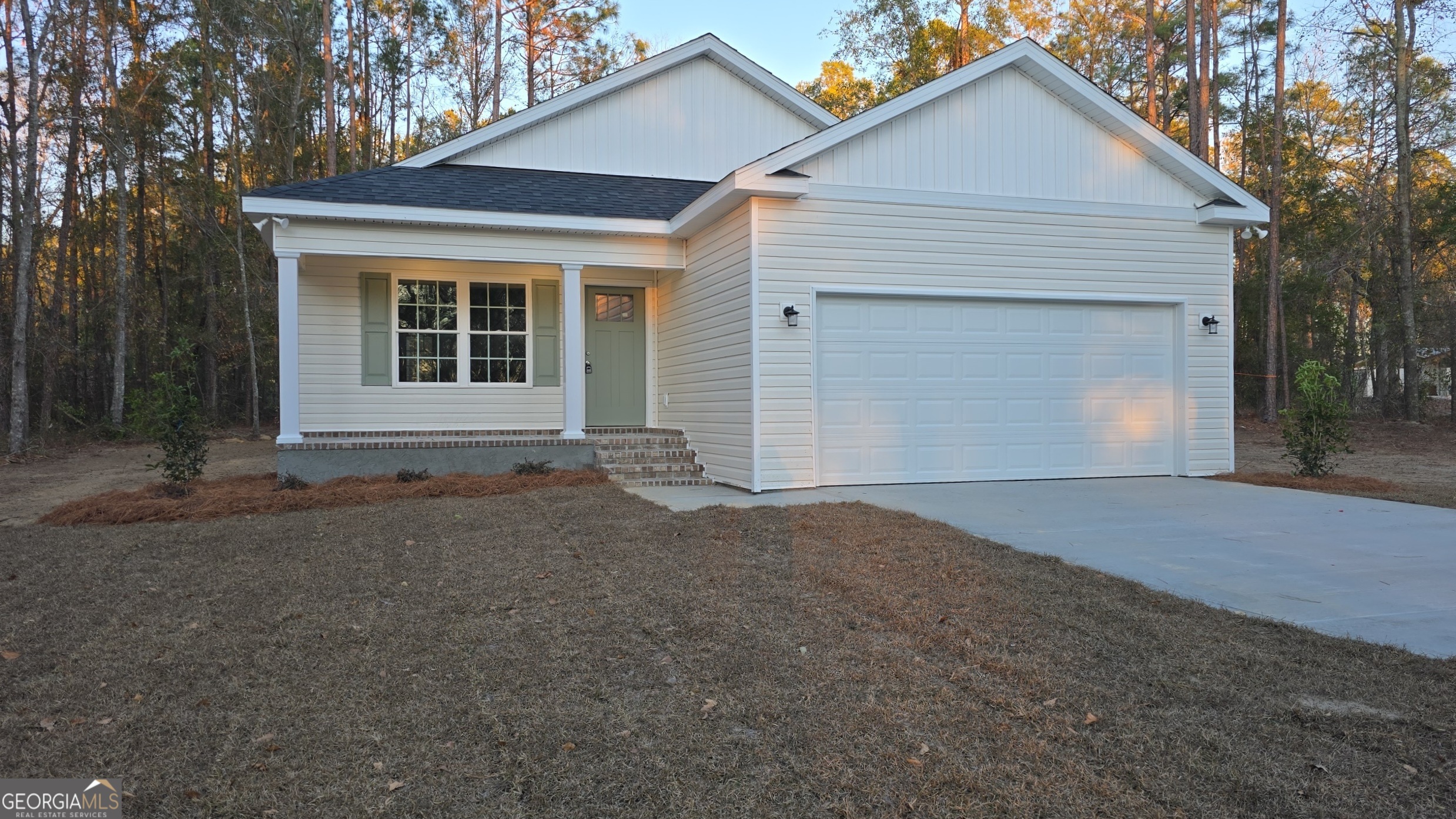 26466 Turner Road Metter, GA 30439 - Photo 2 of 39 a front view of a house with a yard and garage