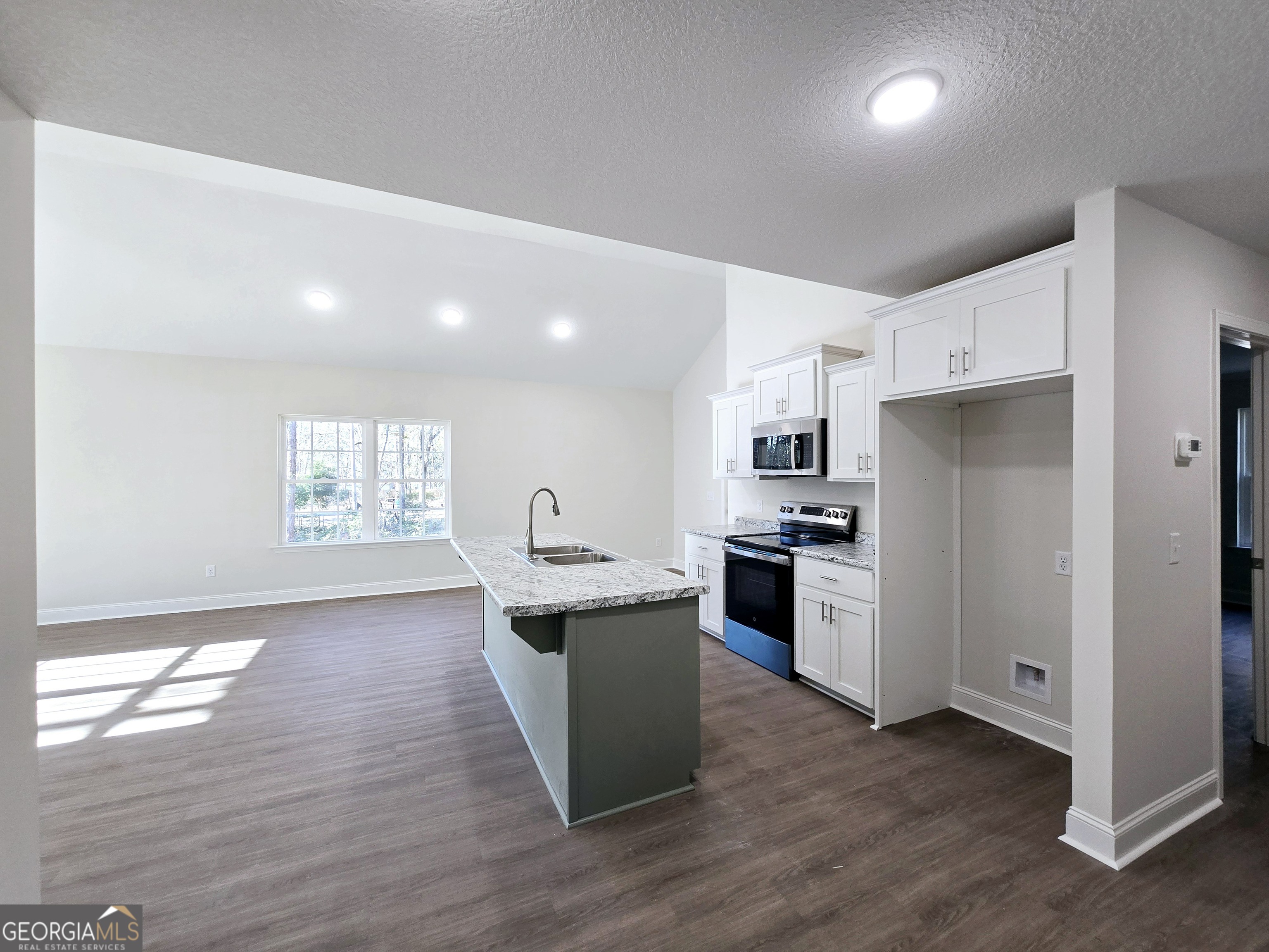 26466 Turner Road Metter, GA 30439 - Photo 26 of 39 a kitchen with kitchen island granite countertop a sink cabinets and stainless steel appliances