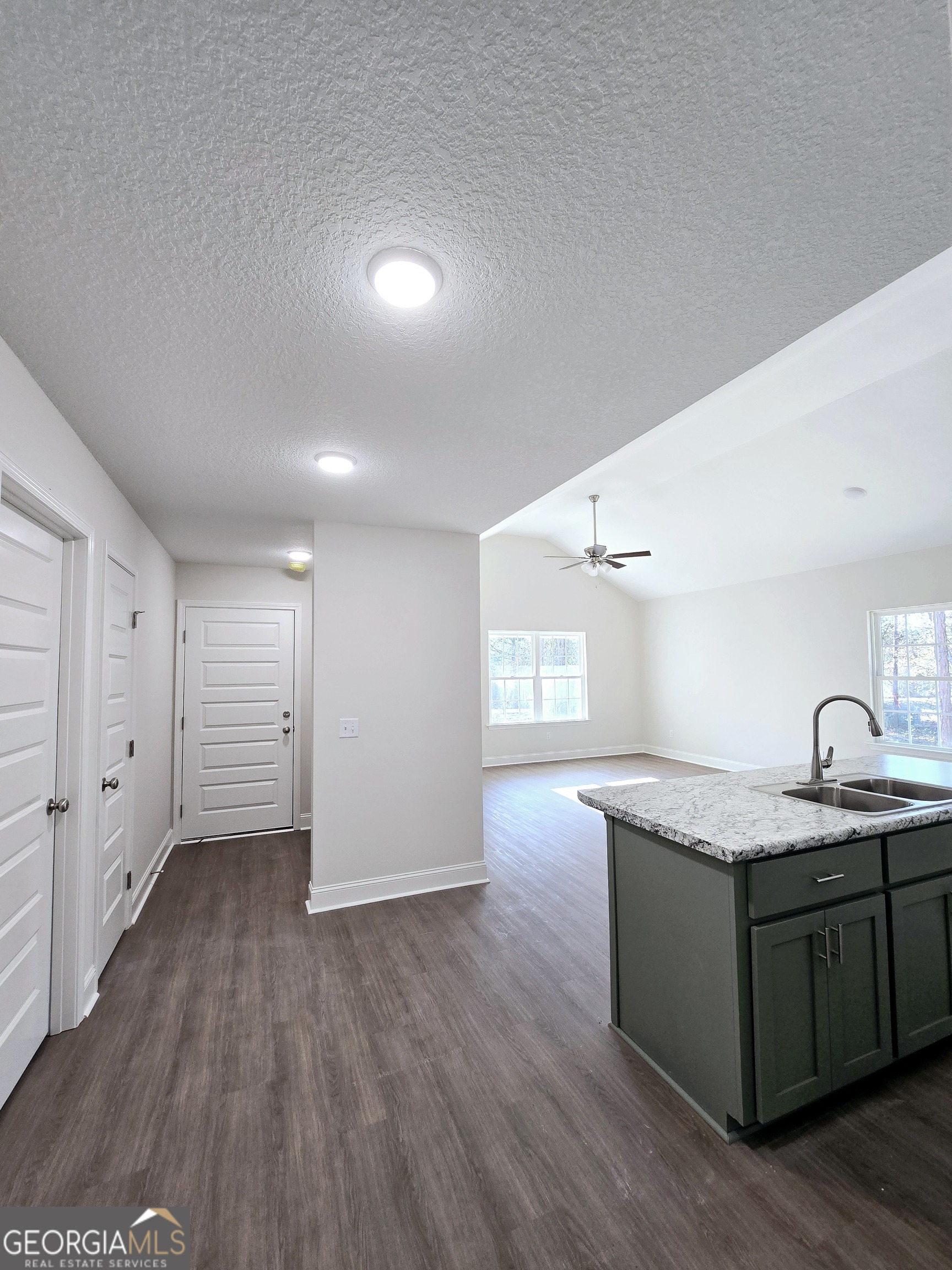 26466 Turner Road Metter, GA 30439 - Photo 34 of 39 a kitchen with granite countertop a sink and wooden floor