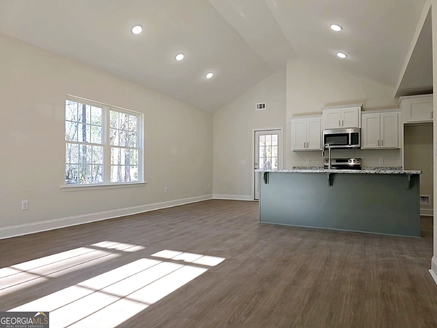 26466 Turner Road Metter, GA 30439 - Photo 6 of 39 a kitchen with stainless steel appliances kitchen island granite countertop a stove a sink and a microwave