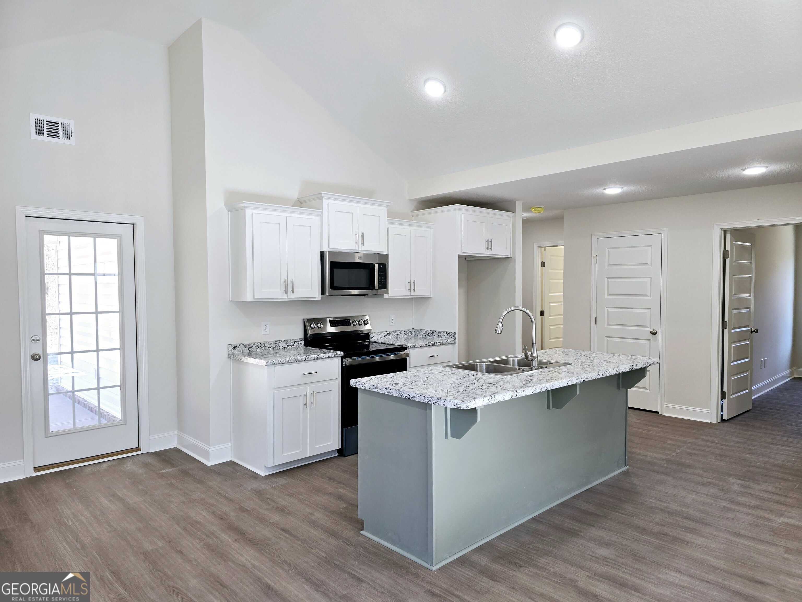 26466 Turner Road Metter, GA 30439 - Photo 7 of 39 a kitchen with stainless steel appliances granite countertop a stove top oven a sink dishwasher and a refrigerator with wooden floor