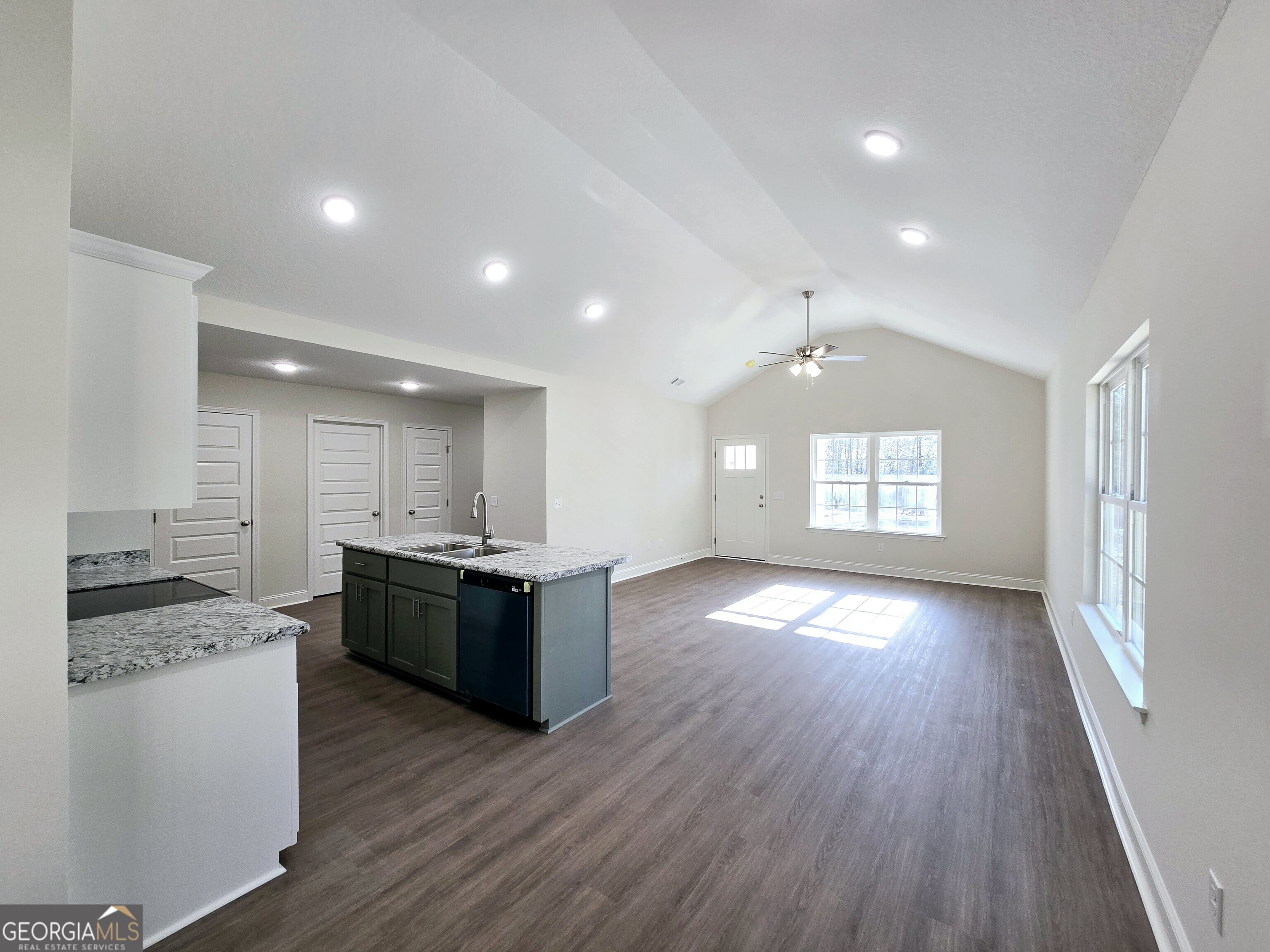 26466 Turner Road Metter, GA 30439 - Photo 8 of 39 a kitchen with stainless steel appliances granite countertop a stove top oven a sink dishwasher and a refrigerator with wooden floors