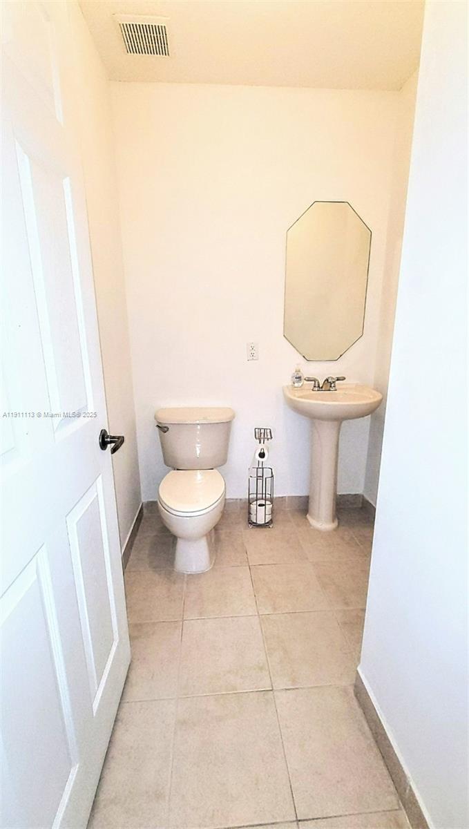 988 Southwest 154th Path Miami, FL 33194 - Photo 12 of 31 a bathroom with a toilet a sink and a mirror
