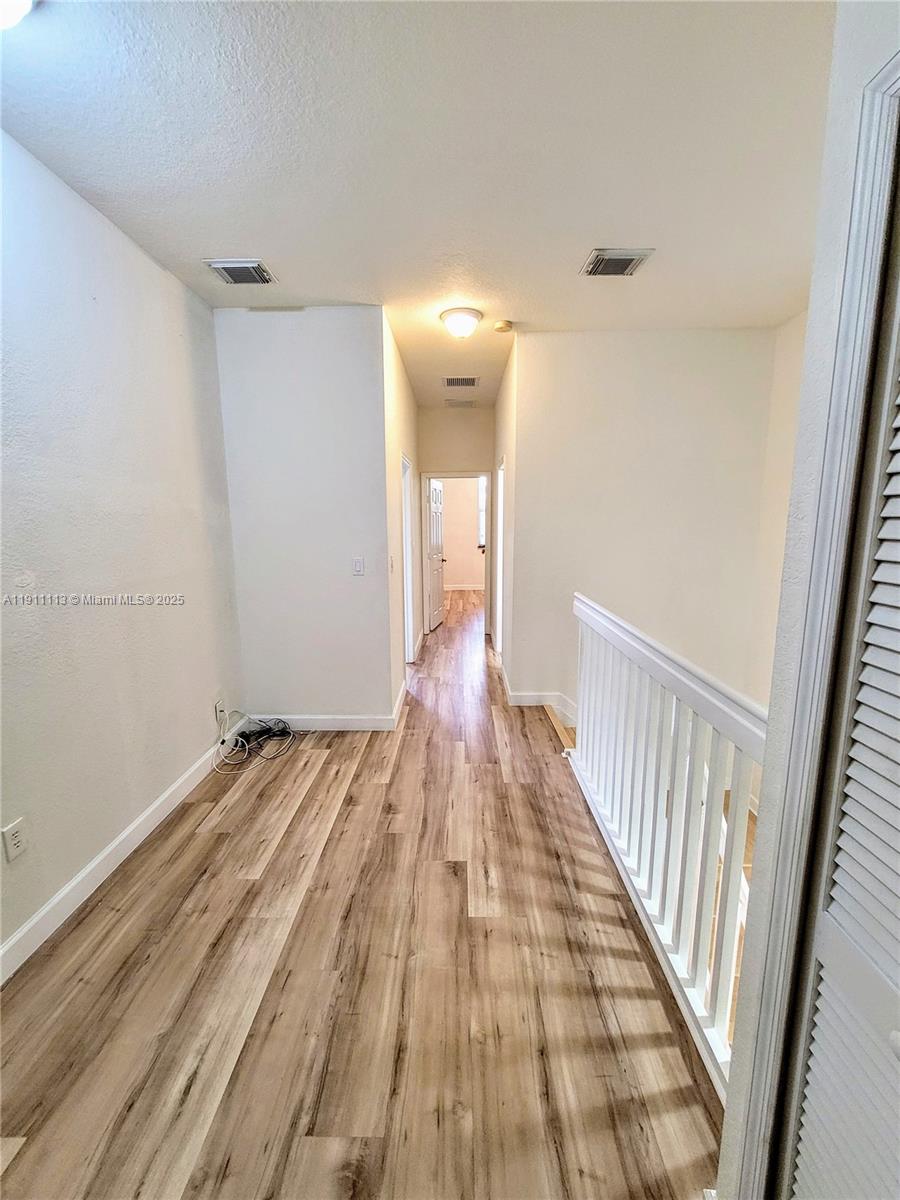 988 Southwest 154th Path Miami, FL 33194 - Photo 20 of 31 a view of a room with wooden floor and staircase