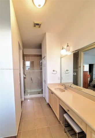 a bathroom with a sink a vanity and mirror