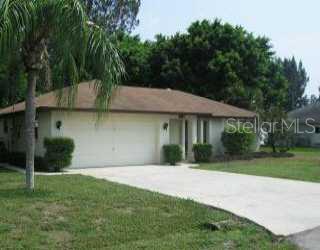 1407 Poinciana Road Venice, FL 34293 - Photo 1 of 1 a front view of a house with a garden and yard