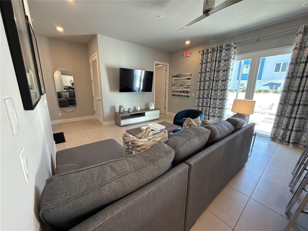7740 Sandy Ridge Drive, Unit 120 Reunion, FL 34747 - Photo 7 of 36 a living room with furniture and a flat screen tv