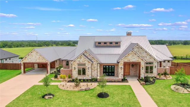 a aerial view of a house with swimming pool garden and patio