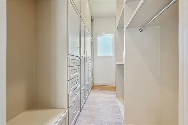 a spacious bathroom with a tub sink and mirror