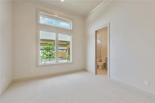 an empty room with fan and entrance