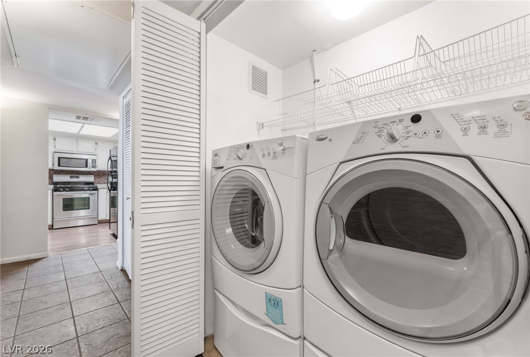 1901 Rio Canyon Court, Unit 102 Las Vegas, NV 89128 - Photo 18 of 23 A well-appointed laundry area features convenient stacked appliances and organized storage.