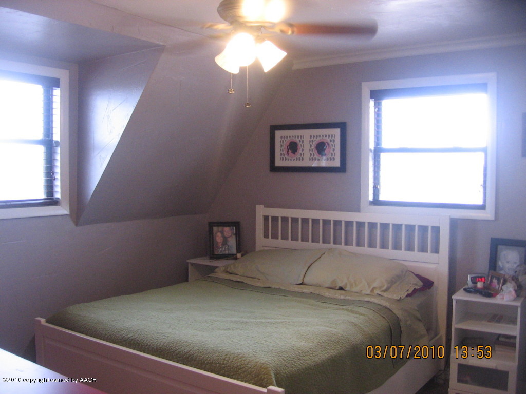 4401 Crockett Street Amarillo, TX 79110 - Photo 12 of 15 a bedroom with a bed and a window
