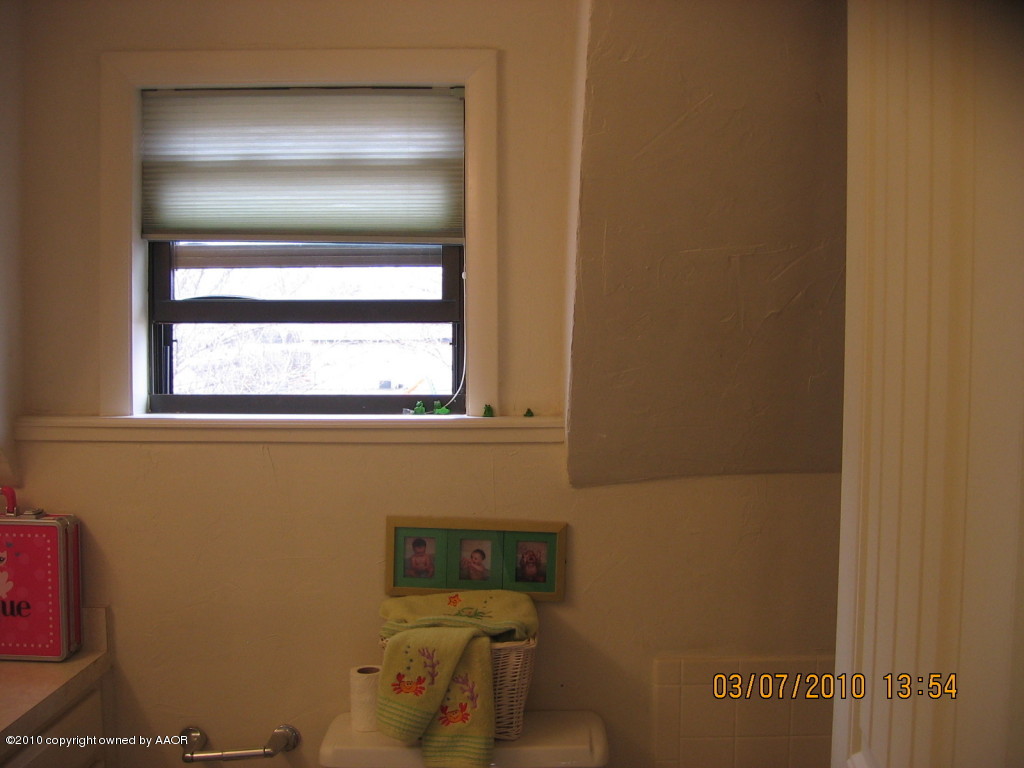 4401 Crockett Street Amarillo, TX 79110 - Photo 14 of 15 a bathroom with a window