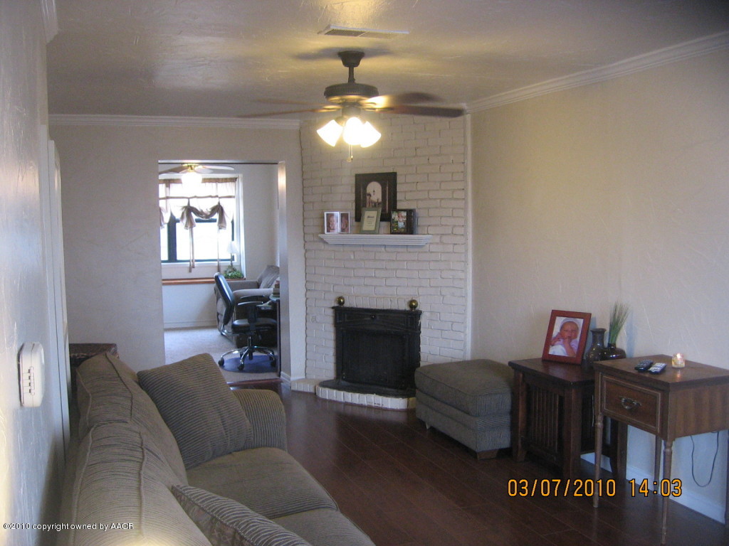 4401 Crockett Street Amarillo, TX 79110 - Photo 2 of 15 a living room with furniture and a fireplace