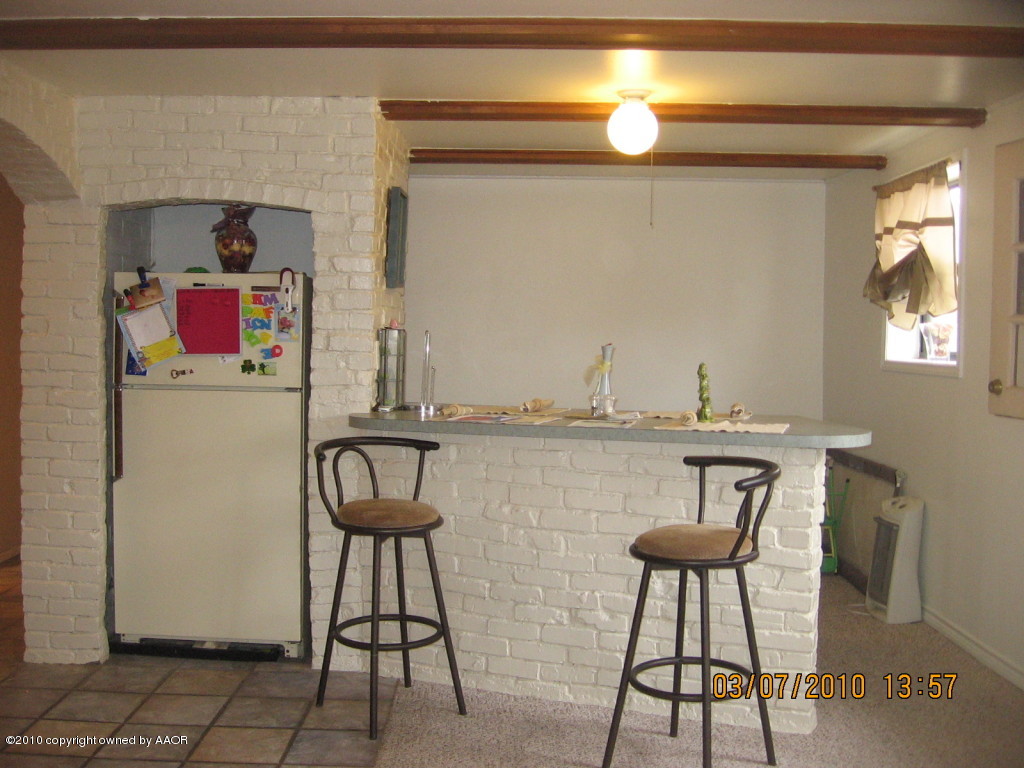 4401 Crockett Street Amarillo, TX 79110 - Photo 5 of 15 a kitchen with a sink cabinets and window