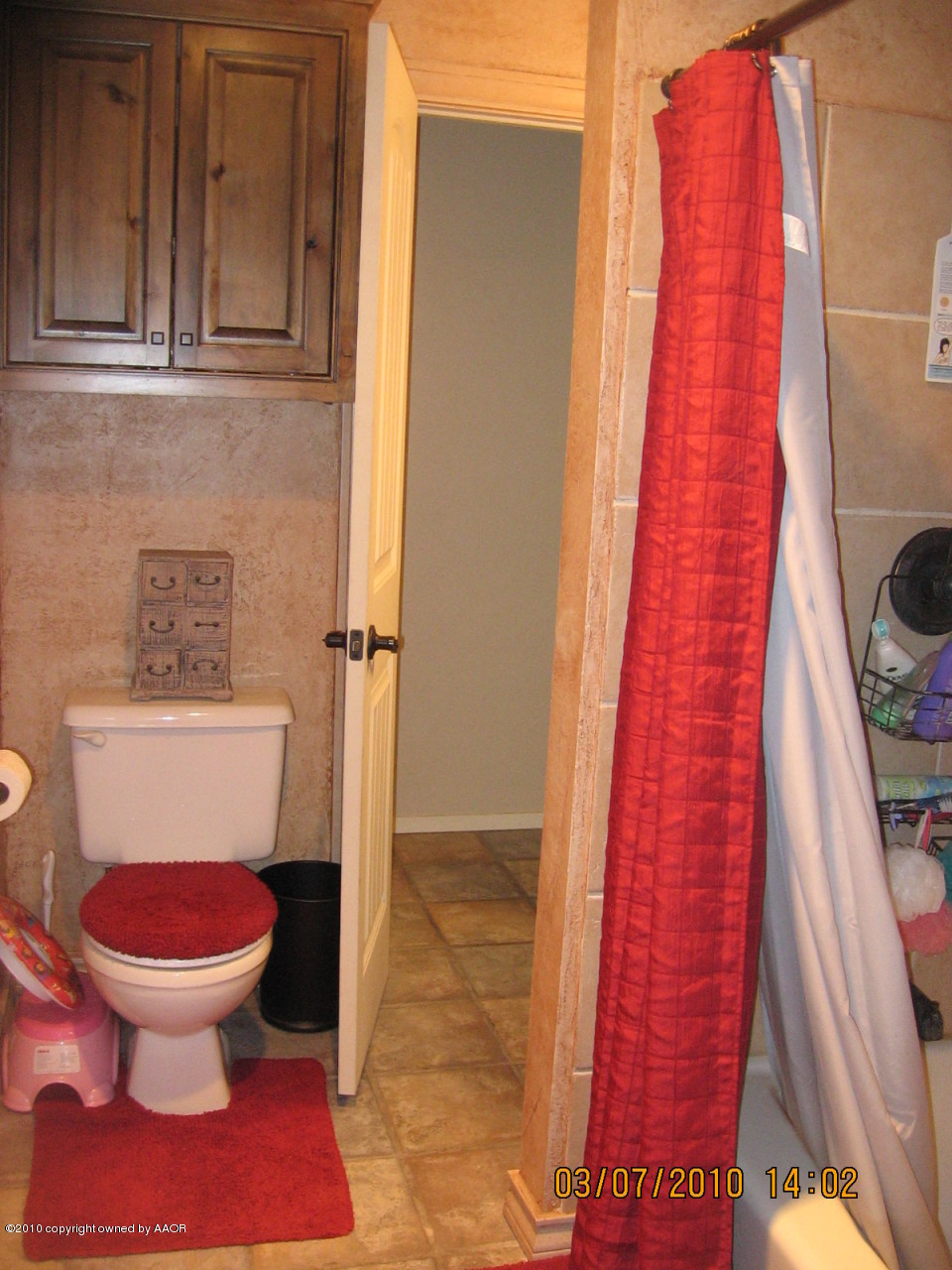 4401 Crockett Street Amarillo, TX 79110 - Photo 7 of 15 a bathroom with a toilet and a shower
