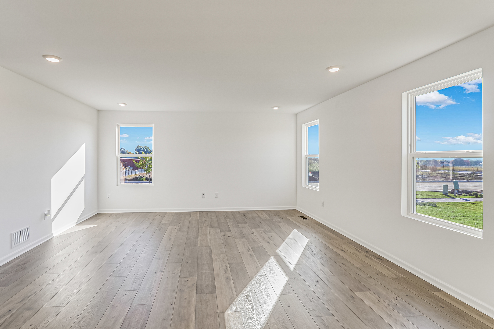 488 Endicott Road South Elgin, IL 60177 - Photo 14 of 30 an empty room with wooden floor and windows