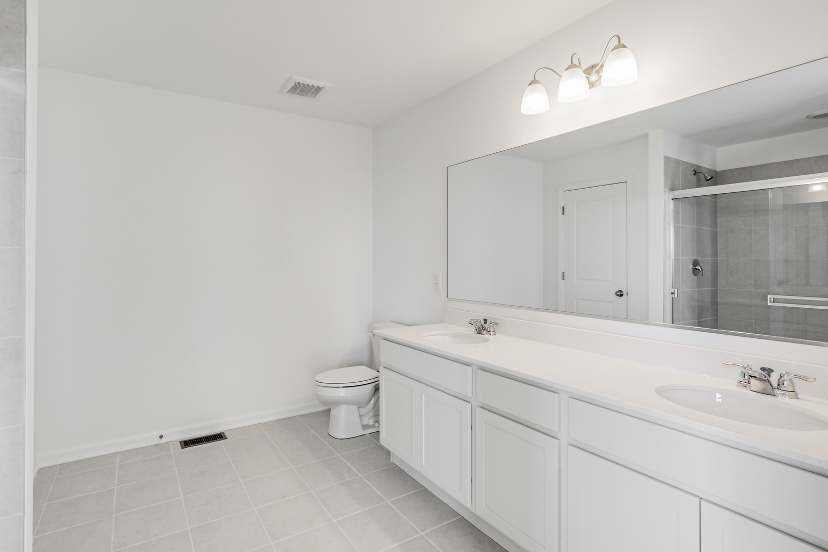 488 Endicott Road South Elgin, IL 60177 - Photo 22 of 30 a spacious bathroom with a toilet sink double vanity and mirror