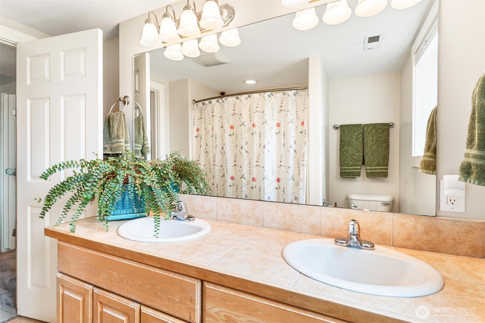 5162 South Wallace Street Seattle, WA 98178 - Photo 27 of 37 a bathroom with a granite countertop sink a mirror and a shower curtain