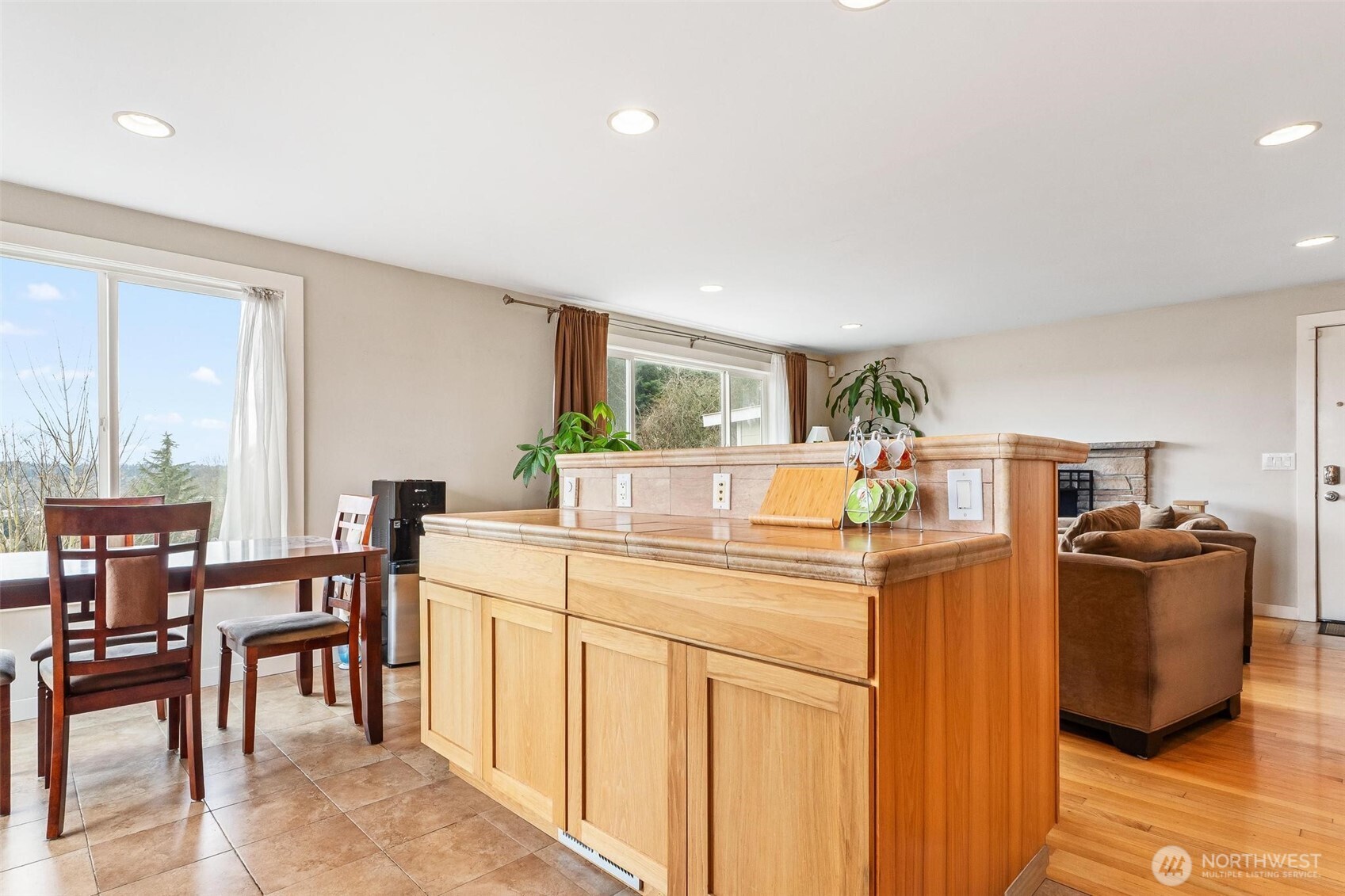 5162 South Wallace Street Seattle, WA 98178 - Photo 8 of 37 a kitchen with stainless steel appliances granite countertop a table and chairs