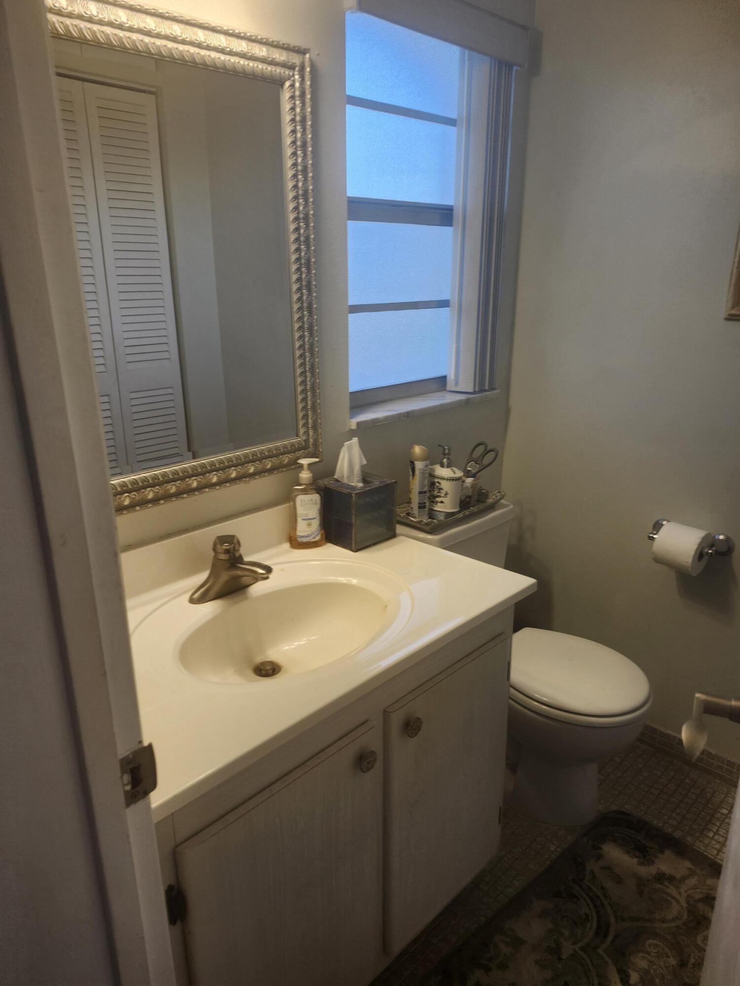 300 Northeast 26th Avenue, Unit 305 Boynton Beach, FL 33435 - Photo 20 of 54 a bathroom with a sink toilet and mirror