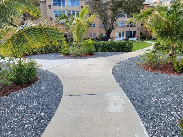 a view of a patio with a table and chairs and potted plants