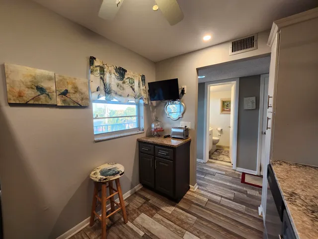 a view of a workspace with furniture and wooden floor