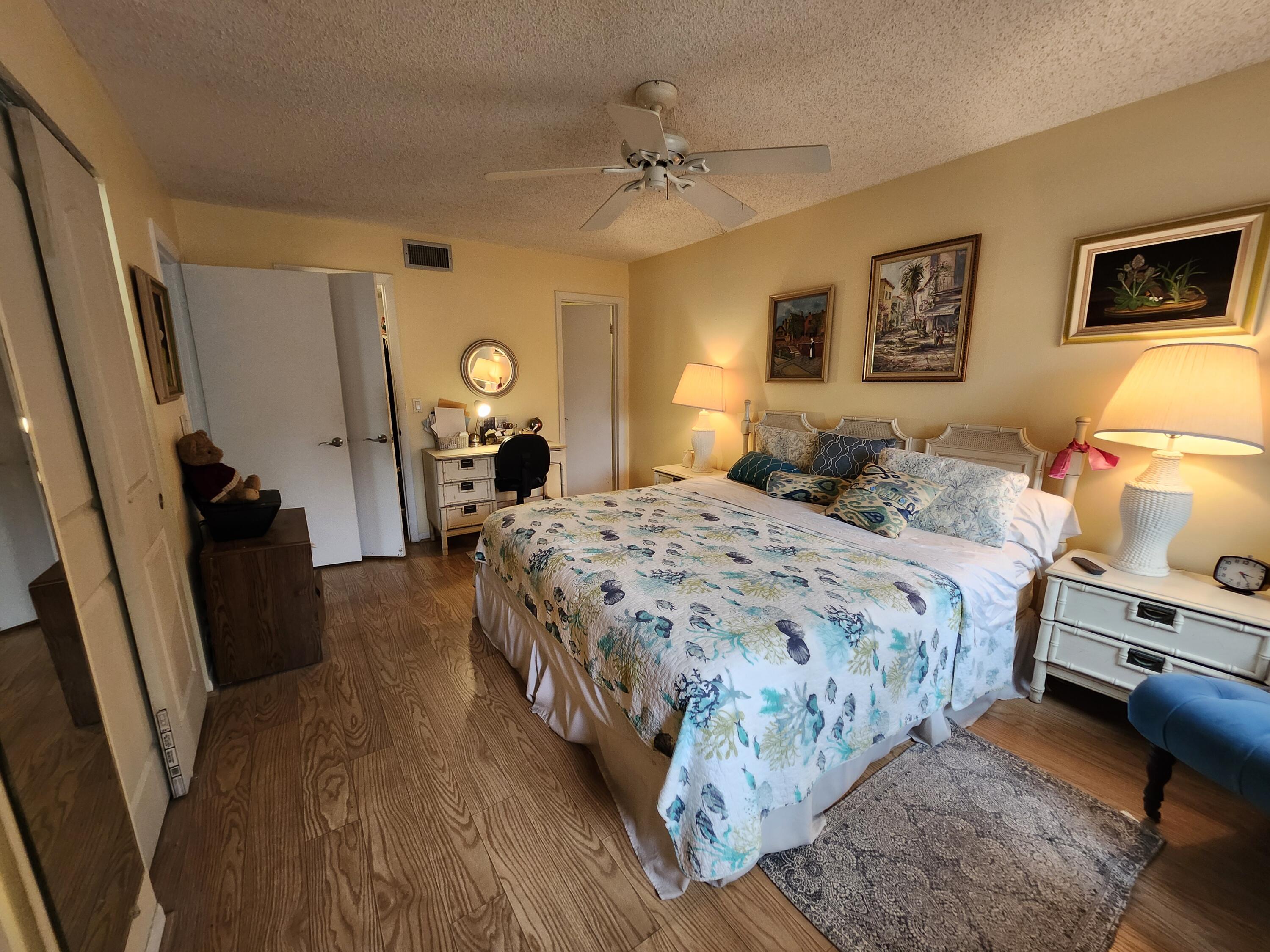 300 Northeast 26th Avenue, Unit 305 Boynton Beach, FL 33435 - Photo 8 of 54 a bedroom with a bed and wooden floor