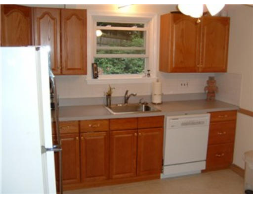 1374 Trapelo Road Waltham, MA 02451 - Photo 6 of 10 a kitchen with stainless steel appliances granite countertop a sink cabinets and a refrigerator