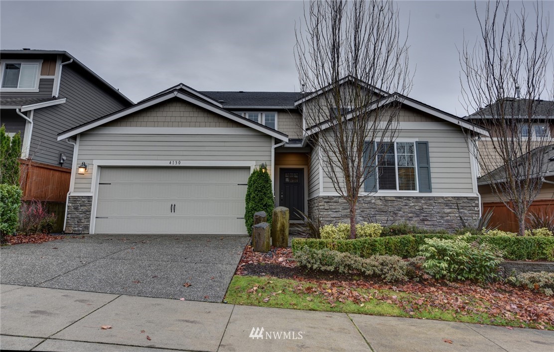 4130 174th Street Southeast Bothell, WA 98012 - Photo 1 of 29 a front view of a house with a yard and garage