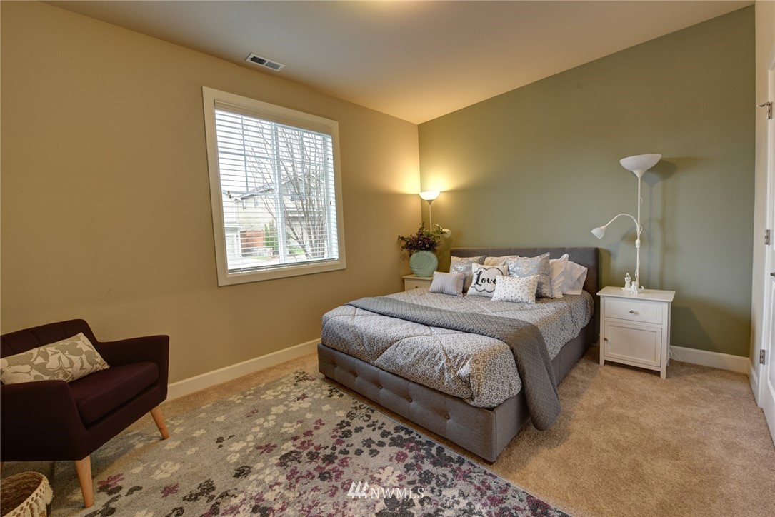 4130 174th Street Southeast Bothell, WA 98012 - Photo 11 of 29 a bedroom with a bed window and a couch